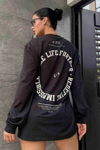 Front View of Black the TLF Redefine Original Cotton Luxe Oversized LS Tee that features a bold back graphic in an oversized fit. 