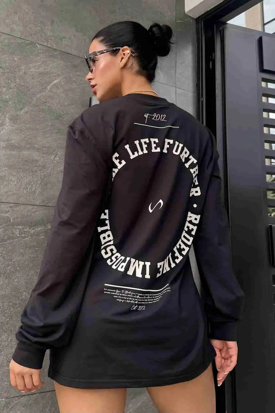Front View of Black the TLF Redefine Original Cotton Luxe Oversized LS Tee that features a bold back graphic in an oversized fit. 