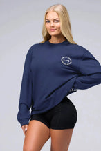 Front View of Blue the TLF Redefine Original Cotton Luxe Oversized LS Tee that features a bold back graphic in an oversized fit. 