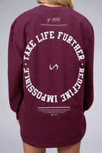Back View of Red the TLF Redefine Original Cotton Luxe Oversized LS Tee that features a bold back graphic in an oversized fit. 