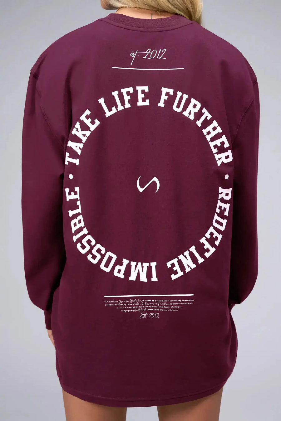 Back View of Red the TLF Redefine Original Cotton Luxe Oversized LS Tee that features a bold back graphic in an oversized fit. 