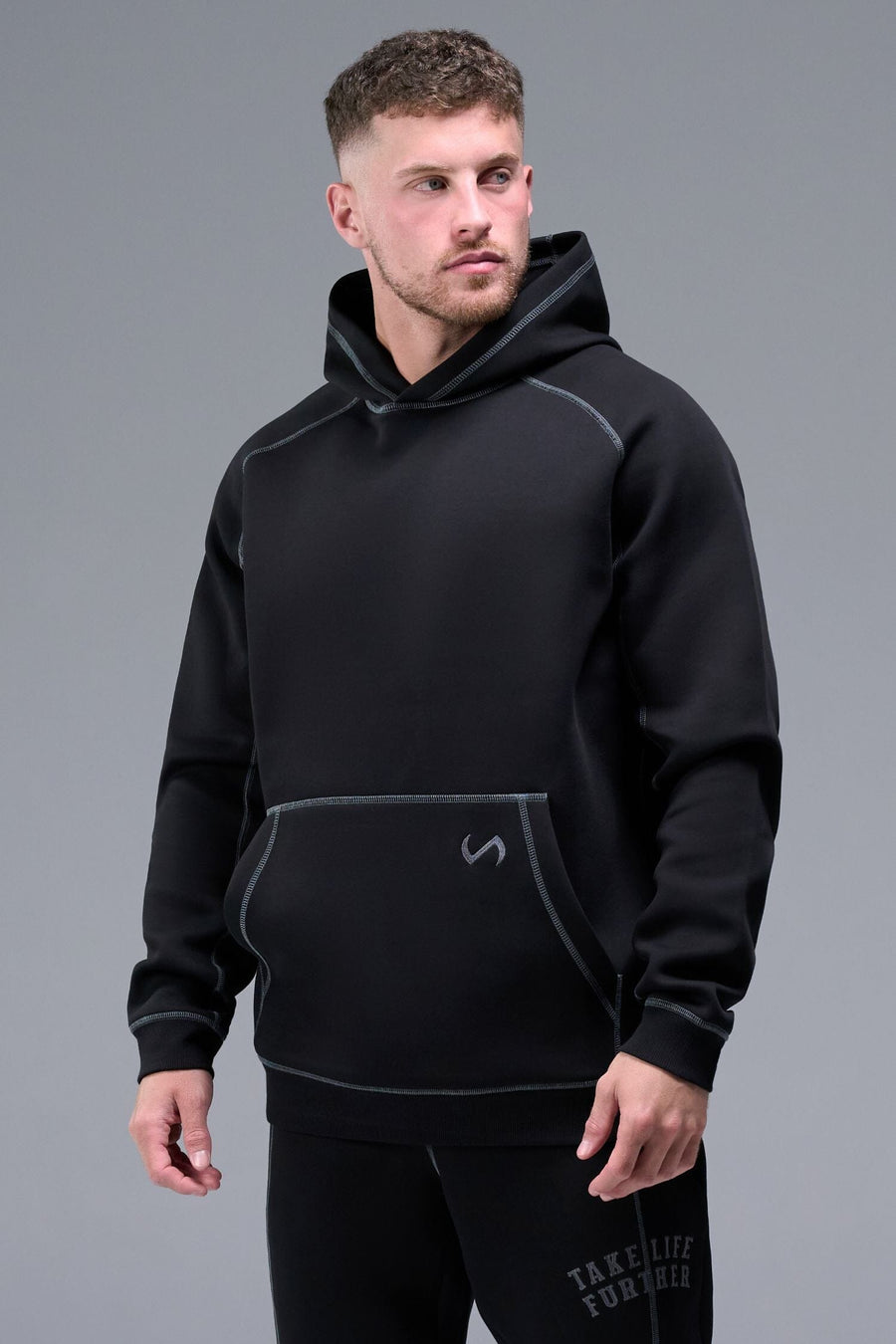 Front View of Black TLF Scuba Tech Contrast Stitch Hoodie, featuring 3 panel hood, Kangaroo pockets and contrast stitching for streetwear aesthetic 