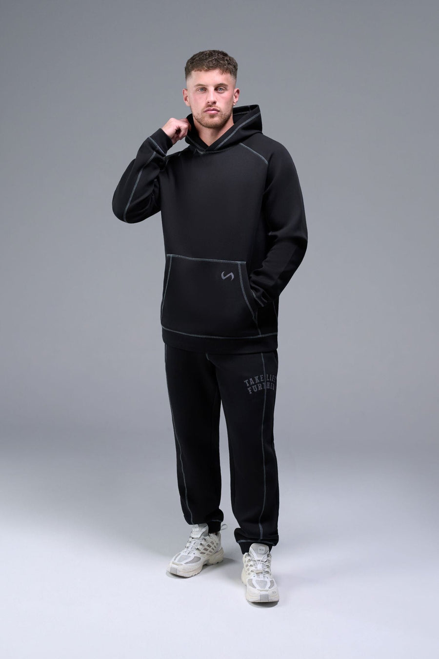 Front View of Black TLF Scuba Tech Contrast Stitch Hoodie, featuring 3 panel hood, Kangaroo pockets and contrast stitching for streetwear aesthetic 