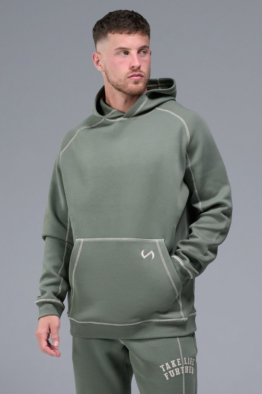 Front View of Green TLF Scuba Tech Contrast Stitch Hoodie, featuring 3 panel hood, Kangaroo pockets and contrast stitching for streetwear aesthetic 