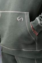 Detail Front View of Green TLF Scuba Tech Contrast Stitch Hoodie, featuring 3 panel hood, Kangaroo pockets and contrast stitching for streetwear aesthetic 