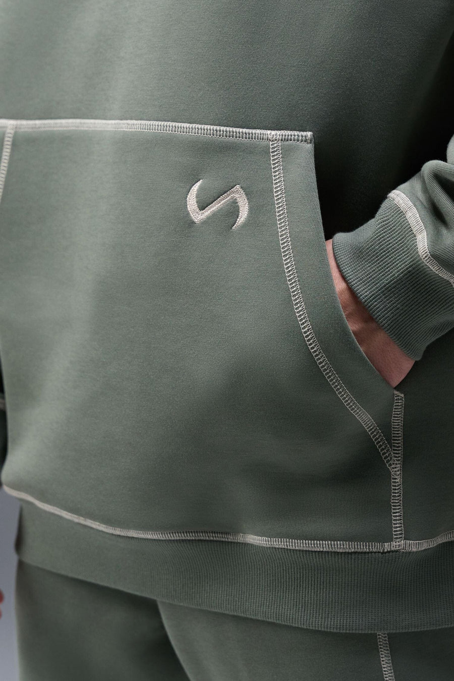 Detail Front View of Green TLF Scuba Tech Contrast Stitch Hoodie, featuring 3 panel hood, Kangaroo pockets and contrast stitching for streetwear aesthetic 