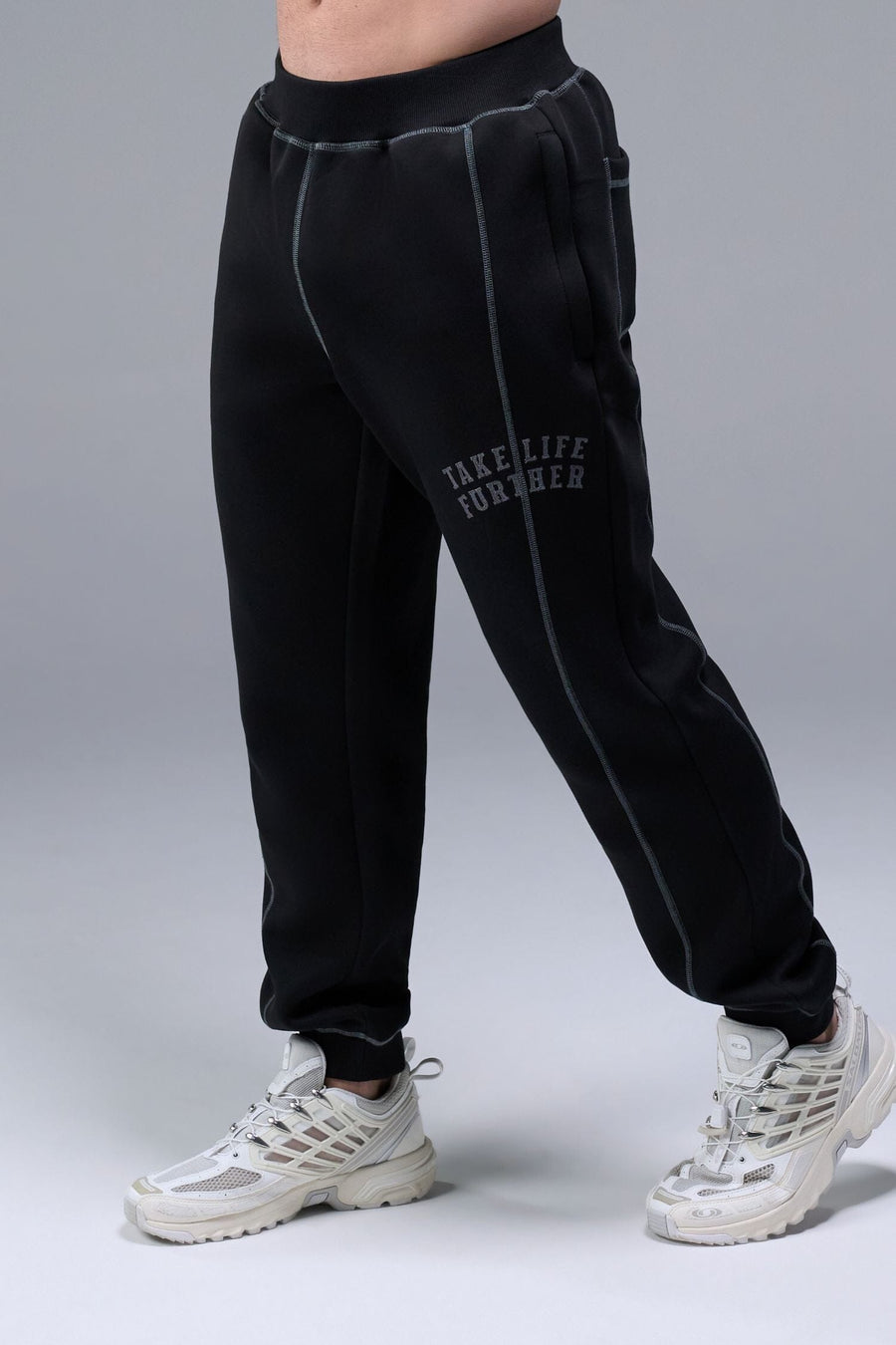 Front View of Black TLF Scuba Tech Contrast Stitch Joggers, featuring side zipper pockets and contrast stitching for streetwear aesthetic 