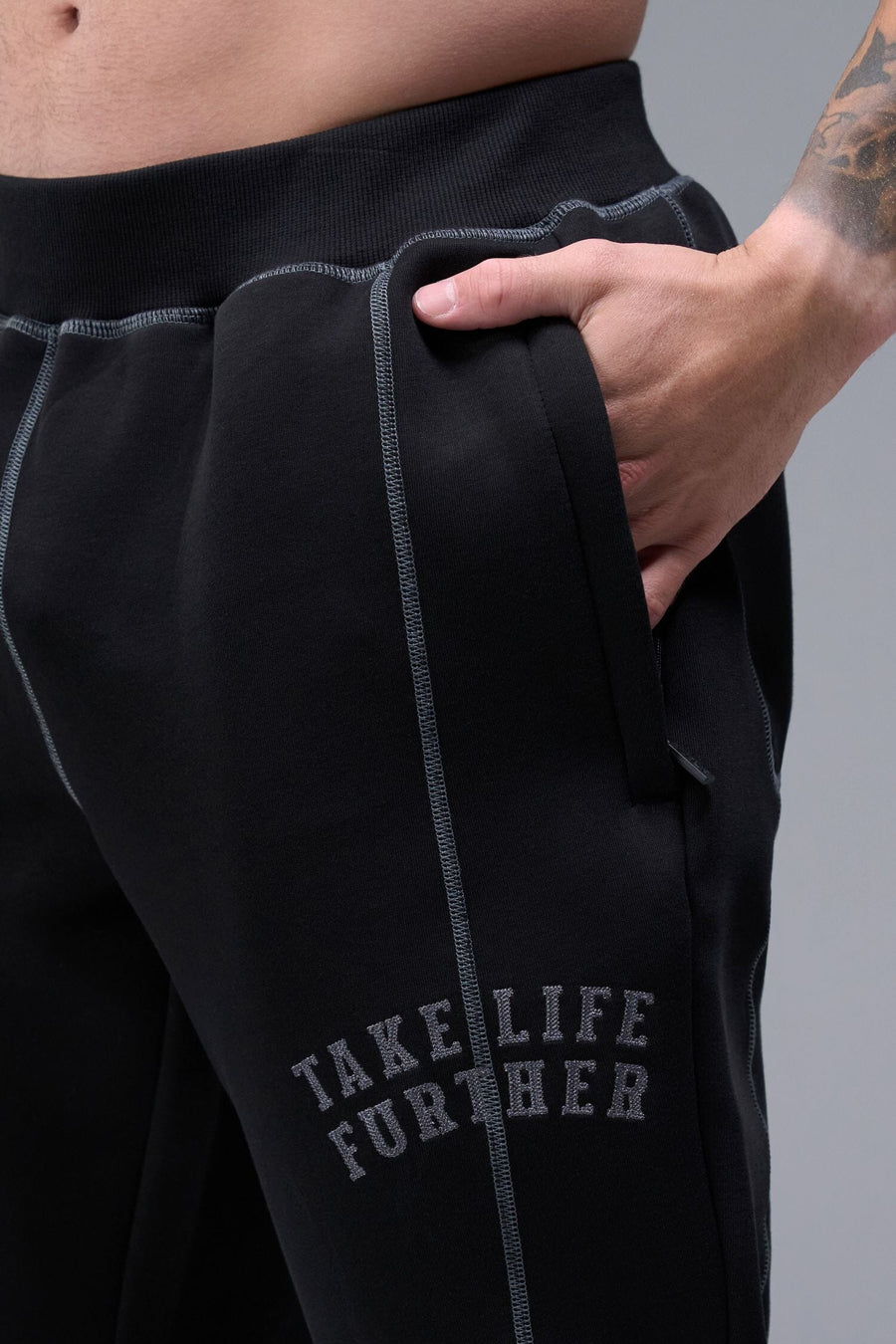 Detail Front View of Black TLF Scuba Tech Contrast Stitch Joggers, featuring side zipper pockets and contrast stitching for streetwear aesthetic 