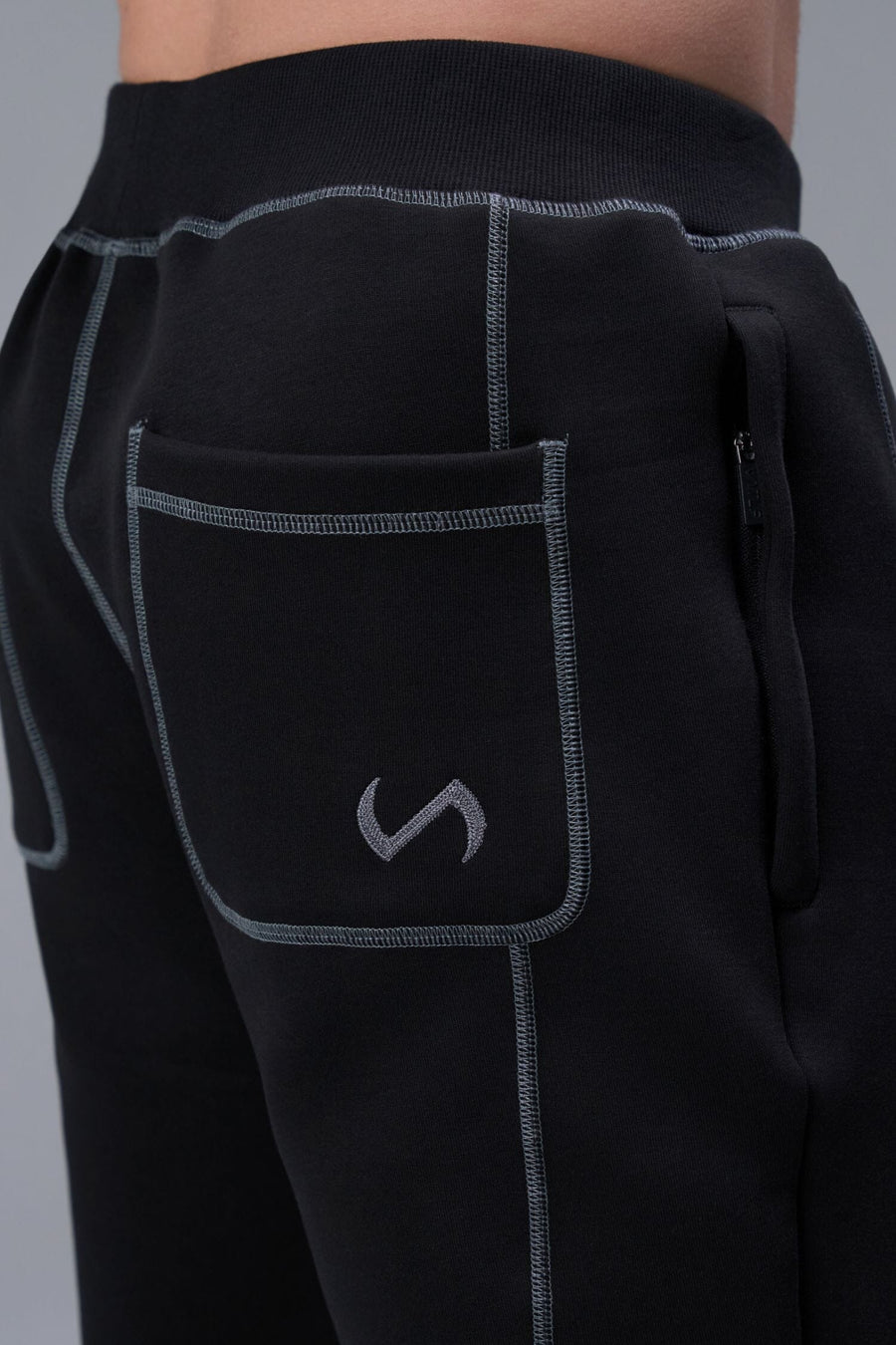 Detail Back View of Black TLF Scuba Tech Contrast Stitch Joggers, featuring side zipper pockets and contrast stitching for streetwear aesthetic 
