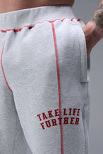 Detail Front View of Gray TLF Scuba Tech Contrast Stitch Joggers, featuring side zipper pockets and contrast stitching for streetwear aesthetic 