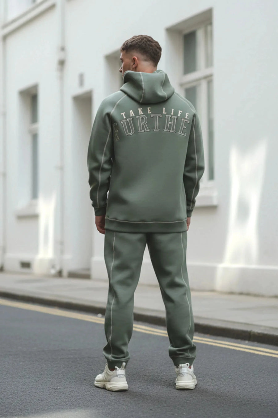 Back View of Green TLF Scuba Tech Contrast Stitch Joggers, featuring side zipper pockets and contrast stitching for streetwear aesthetic 
