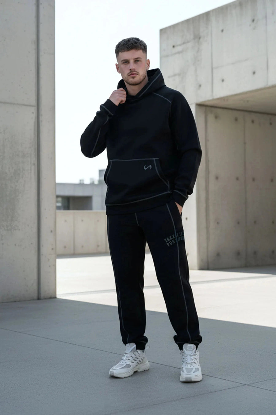 Front View of Black TLF Scuba Tech Contrast Stitch Joggers, featuring side zipper pockets and contrast stitching for streetwear aesthetic 