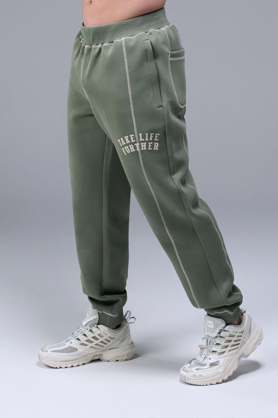 Front View of Green TLF Scuba Tech Contrast Stitch Joggers, featuring side zipper pockets and contrast stitching for streetwear aesthetic 