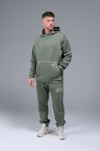 Front View of Green TLF Scuba Tech Contrast Stitch Joggers, featuring side zipper pockets and contrast stitching for streetwear aesthetic 