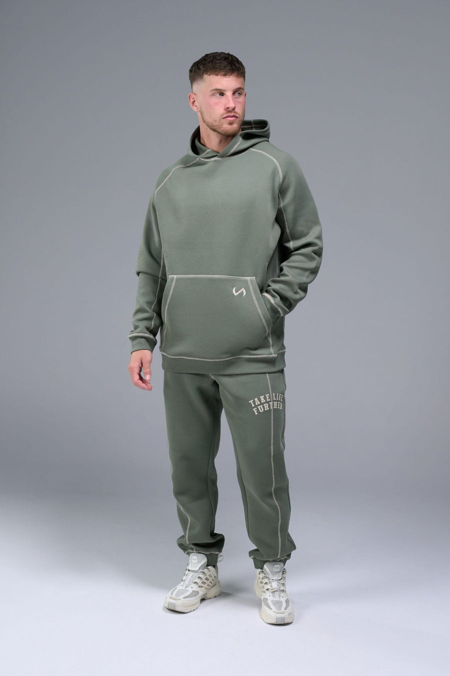 Front View of Green TLF Scuba Tech Contrast Stitch Joggers, featuring side zipper pockets and contrast stitching for streetwear aesthetic 