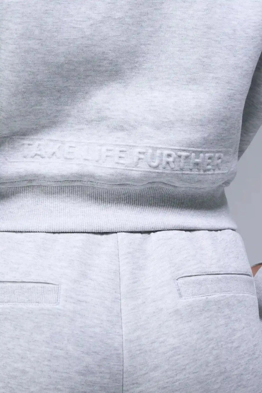 Back View of Gray TLF Scuba Tech Cropped Zip Up Jacket, featuring side zipper pockets, thumbholes and a cropped length 