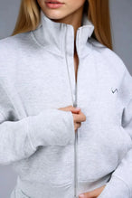 Front View of Gray TLF Scuba Tech Cropped Zip Up Jacket, featuring side zipper pockets, thumbholes and a cropped length 