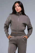 Front View of Brown TLF Scuba Tech Cropped Zip Up Jacket, featuring side zipper pockets, thumbholes and a cropped length 