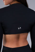 Detail Back View of Black Tempo Bolero Shrug featuring thumbholes, designed for workouts and all day wear 
