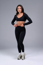Front View of Black Tempo Bolero Shrug featuring thumbholes, designed for workouts and all day wear 