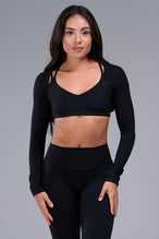 Front View of Black Tempo Bolero Shrug featuring thumbholes, designed for workouts and all day wear 