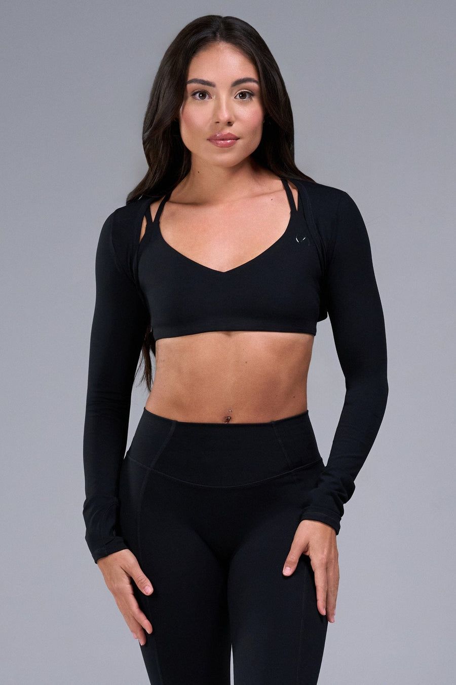 Front View of Black Tempo Bolero Shrug featuring thumbholes, designed for workouts and all day wear 