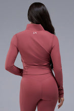 Back View of Orange TLF Tempo Cropped Zip Up Jacket featuring thumbholes and cropped length for gym and lifestyle wear 
