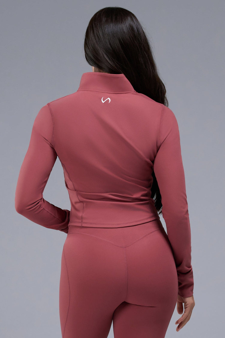 Back View of Orange TLF Tempo Cropped Zip Up Jacket featuring thumbholes and cropped length for gym and lifestyle wear 