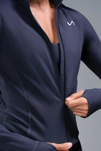 Detail Front View of Blue TLF Tempo Cropped Zip Up Jacket featuring thumbholes and cropped length for gym and lifestyle wear 