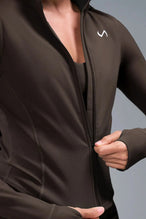 Detail Front View of Brwon TLF Tempo Cropped Zip Up Jacket featuring thumbholes and cropped length for gym and lifestyle wear 