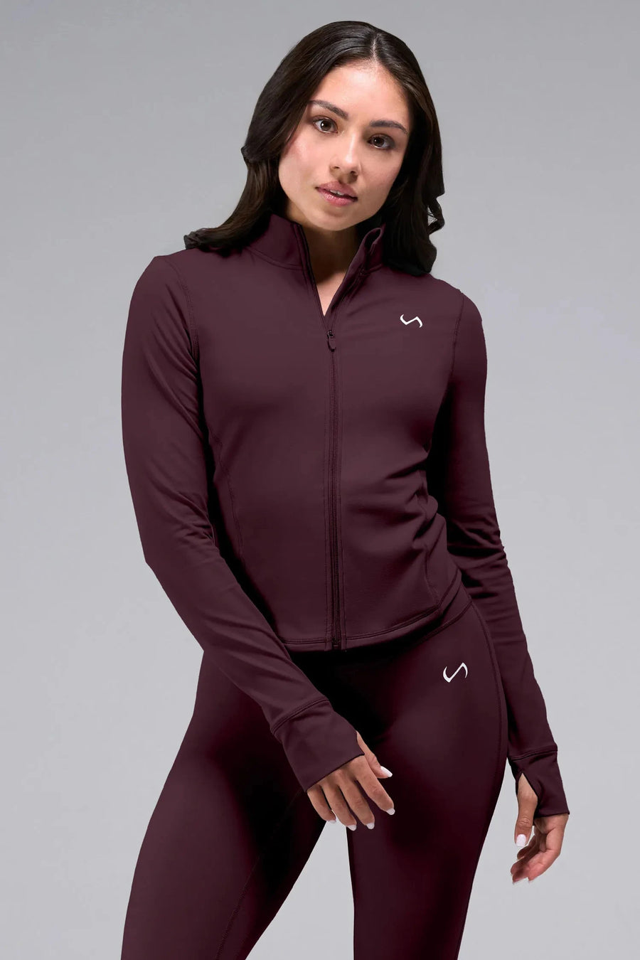 Front View of Wine TLF Tempo Cropped Zip Up Jacket featuring thumbholes and cropped length for gym and lifestyle wear 