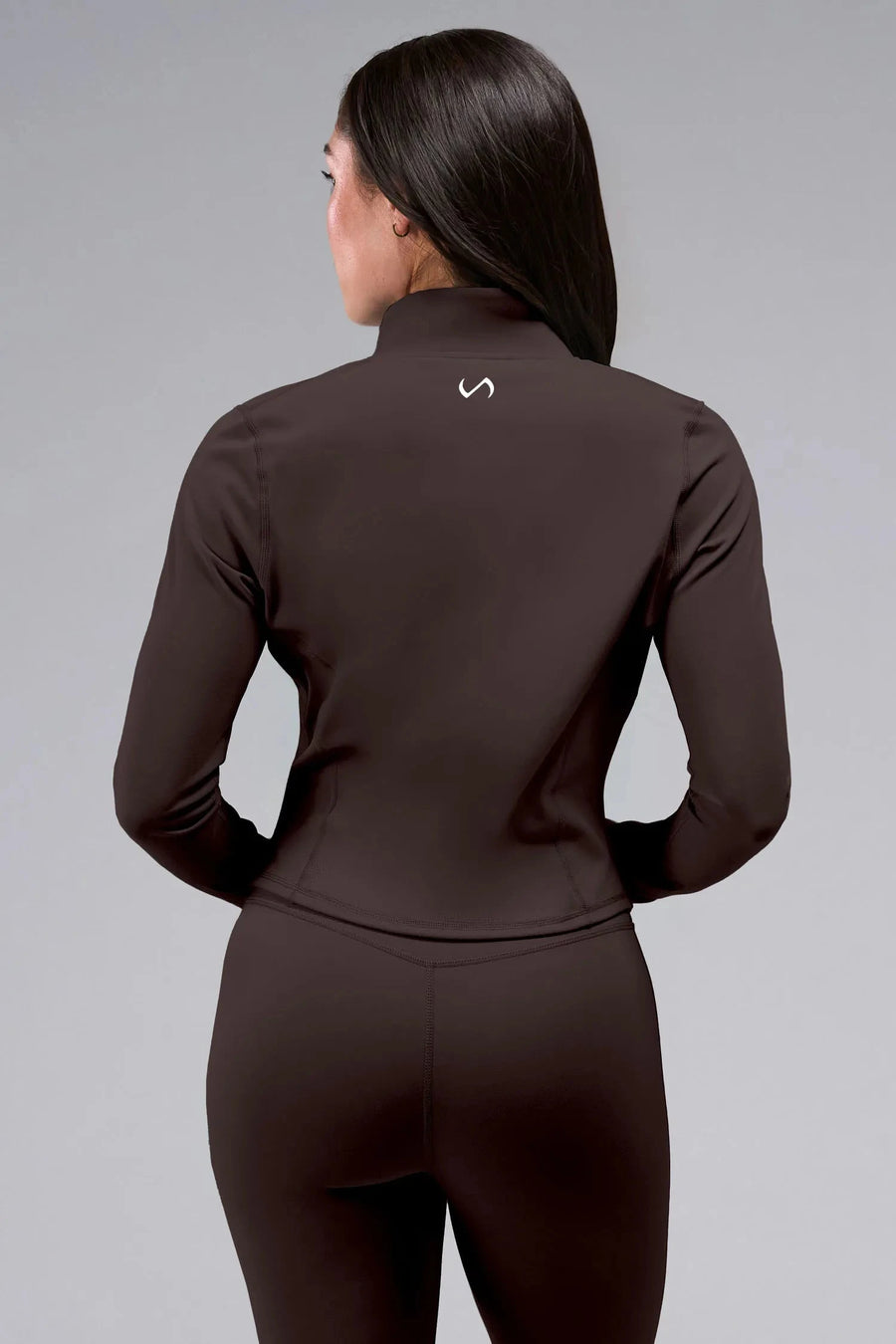Back View of Brown TLF Tempo Cropped Zip Up Jacket featuring thumbholes and cropped length for gym and lifestyle wear 