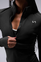 Detail Front View of Black TLF Tempo Cropped Zip Up Jacket featuring thumbholes and cropped length for gym and lifestyle wear 