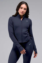 Front View of Blue TLF Tempo Cropped Zip Up Jacket featuring thumbholes and cropped length for gym and lifestyle wear 