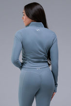 Back View of Blue TLF Tempo Cropped Zip Up Jacket featuring thumbholes and cropped length for gym and lifestyle wear 