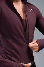 Detail Front View of Wine TLF Tempo Cropped Zip Up Jacket featuring thumbholes and cropped length for gym and lifestyle wear 
