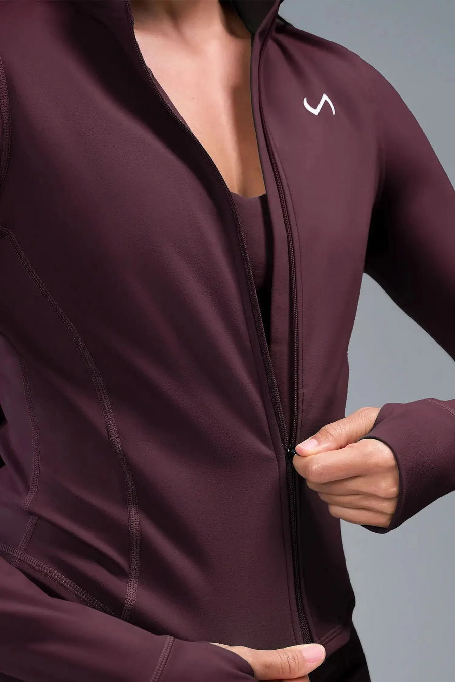 Detail Front View of Wine TLF Tempo Cropped Zip Up Jacket featuring thumbholes and cropped length for gym and lifestyle wear 