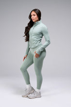 Side View Of Women's Tempo Cropped Zip Up Jacket in Sage Green