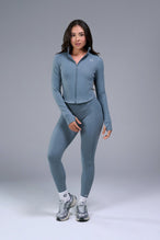 Front View of Blue TLF Tempo Cropped Zip Up Jacket featuring thumbholes and cropped length for gym and lifestyle wear 