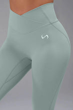 Front View of Green TLF Tempo Flare Leggings, featuring a waist snatching crossover waistband and glute shaping side seam 