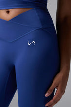 Front View of Blue TLF Tempo Flare Leggings, featuring a waist snatching crossover waistband and glute shaping side seam 