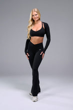 Front View of Black TLF Tempo Flare Leggings, featuring a waist snatching crossover waistband and glute shaping side seam 