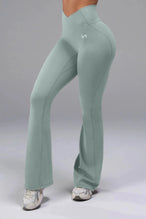 Front View of Green TLF Tempo Flare Leggings, featuring a waist snatching crossover waistband and glute shaping side seam 
