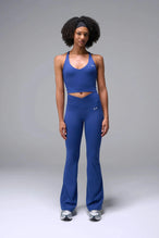 Front View of Blue TLF Tempo Flare Leggings, featuring a waist snatching crossover waistband and glute shaping side seam 