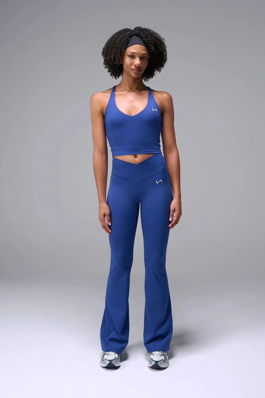Front View of Blue TLF Tempo Flare Leggings, featuring a waist snatching crossover waistband and glute shaping side seam 