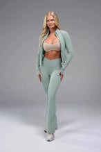 Front View of Green TLF Tempo Flare Leggings, featuring a waist snatching crossover waistband and glute shaping side seam 