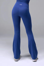 Back View of Blue TLF Tempo Flare Leggings, featuring a waist snatching crossover waistband and glute shaping side seam 
