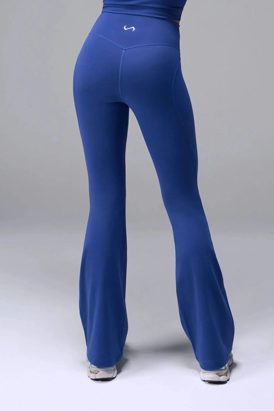 Back View of Blue TLF Tempo Flare Leggings, featuring a waist snatching crossover waistband and glute shaping side seam 