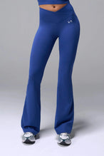 Front View of Blue TLF Tempo Flare Leggings, featuring a waist snatching crossover waistband and glute shaping side seam 