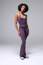 Back View of Purple TLF Tempo Flare Leggings, featuring a waist snatching crossover waistband and glute shaping side seam 